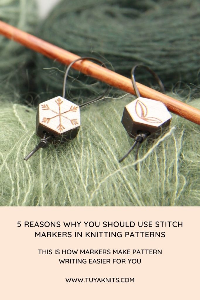 Image for a blog post called '5 reasons why you should include the use of stitch markers in your knitting patterns.' The image has green yarn as a background and a wooden knitting needle with two white stitch markers hanging on the needle.